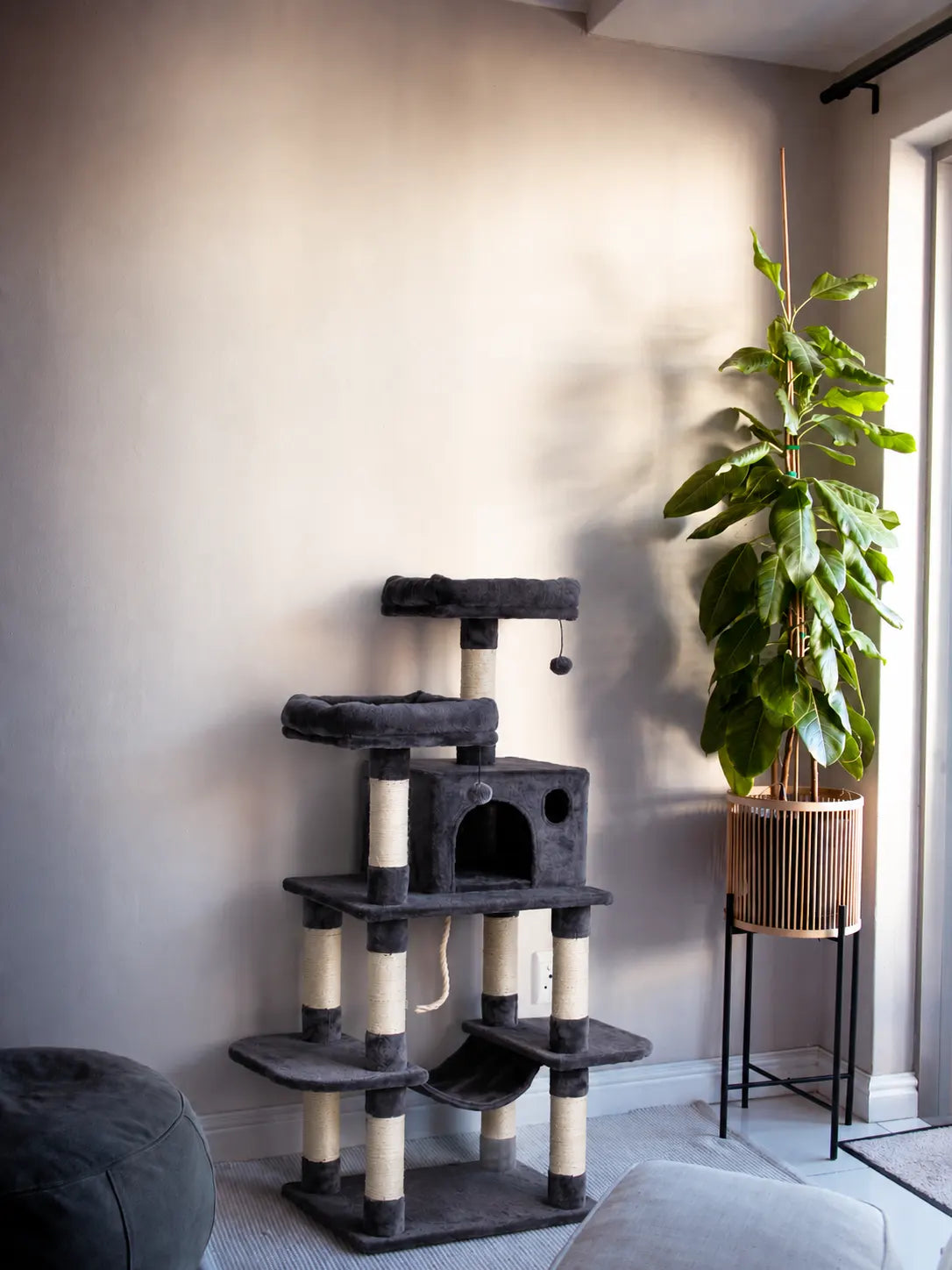 Average traditional floor-standing cat tree with carpeted posts and platforms – bulky and space-consuming compared to modern wall-mounted options